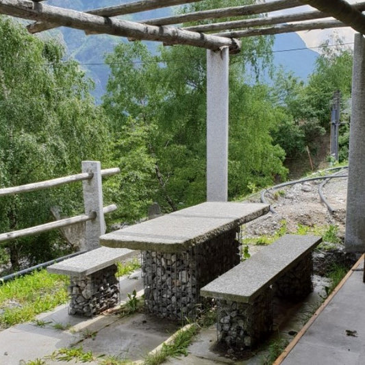 Granite table and two benches set with gabions as legs